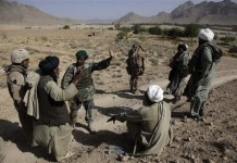 Afghan Civilian talking with a soldier from the Afghan Security Force