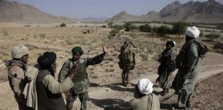 Afghan Civilian talking with a soldier from the Afghan Security Force