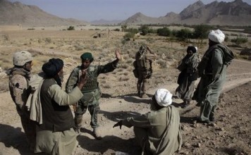 Afghan Civilian talking with a soldier from the Afghan Security Force