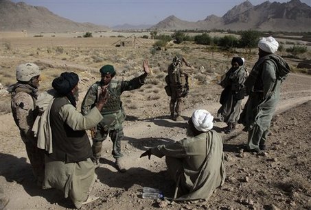 Afghan Civilian talking with a soldier from the Afghan Security Force
